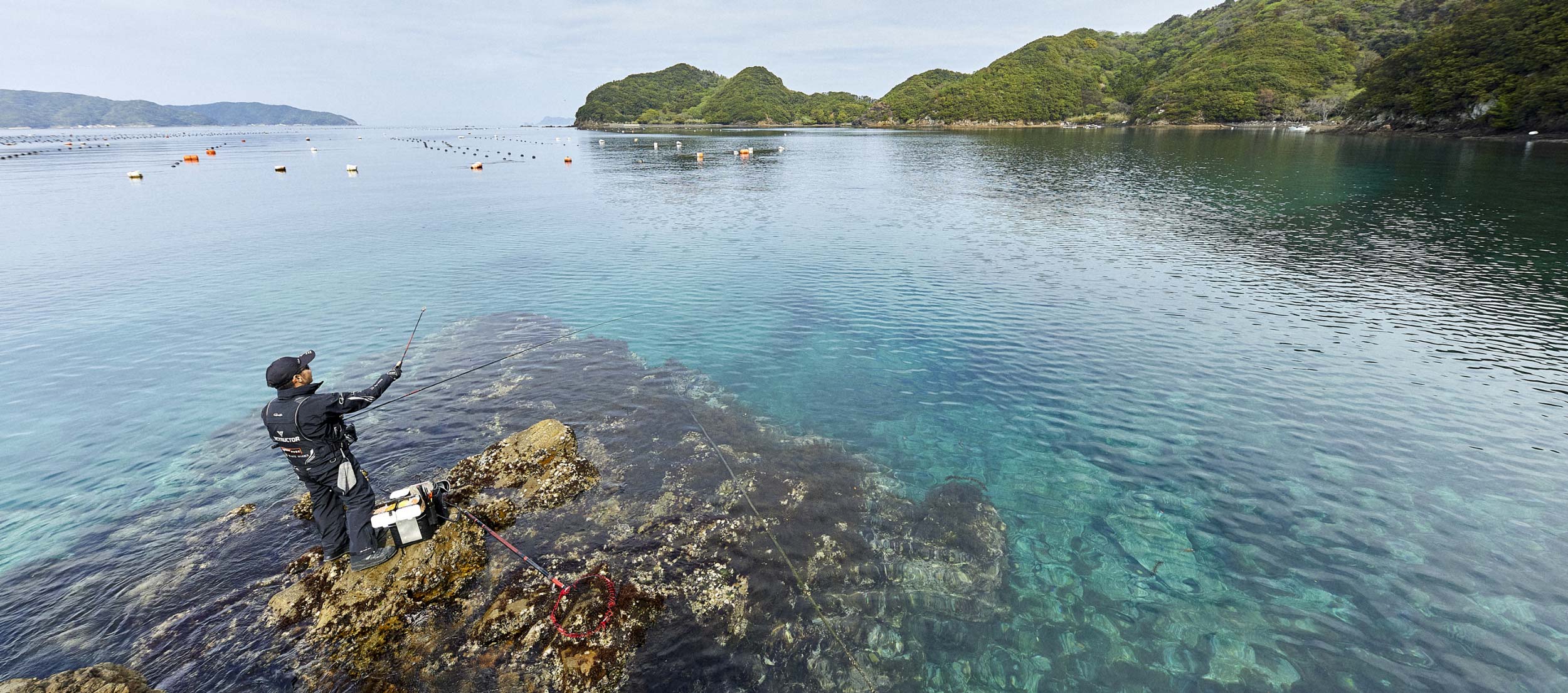 磯に立ち、マキ餌をする沖永